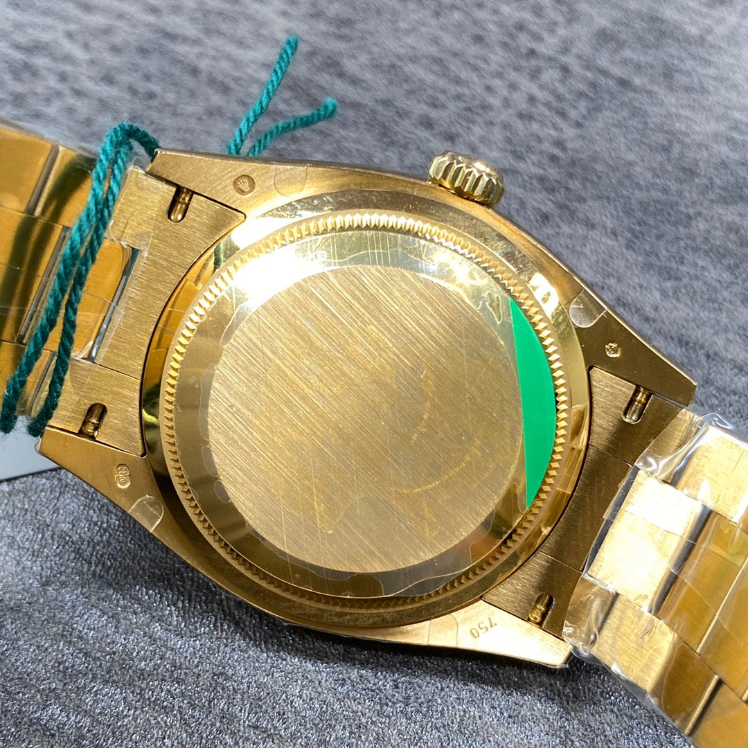 Automatic 36mm watch with green and gold dial